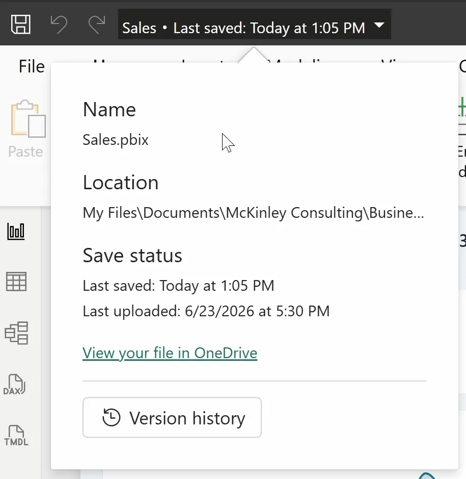 The flyout under the file name in Power BI Desktop. It lists Name, Sales.pbix; Location, a folder in OneDrive; Save status, Last saved: Today at 1:05 PM and Last uploaded: 6/23/2026 at 5:30 PM; a View your file in OneDrive link; and a Version history button.